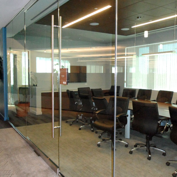 Balfour Beatty office heavy glass walls pivot doors installation